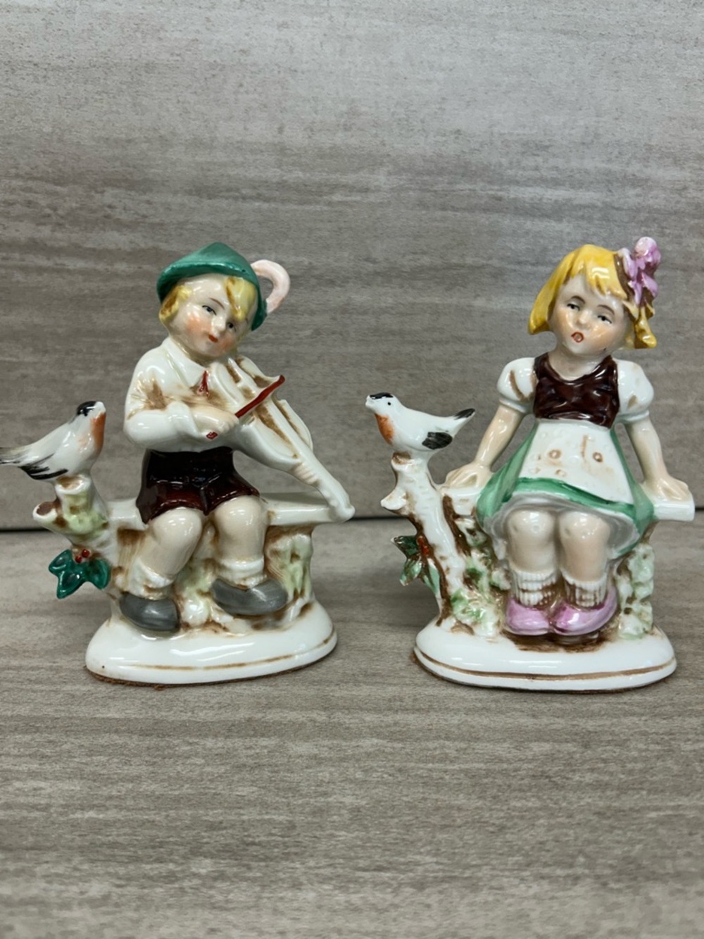 Antique German porcelain figurines,boy, and girl w/bird. 4”